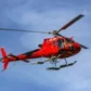 red helicopter in flight